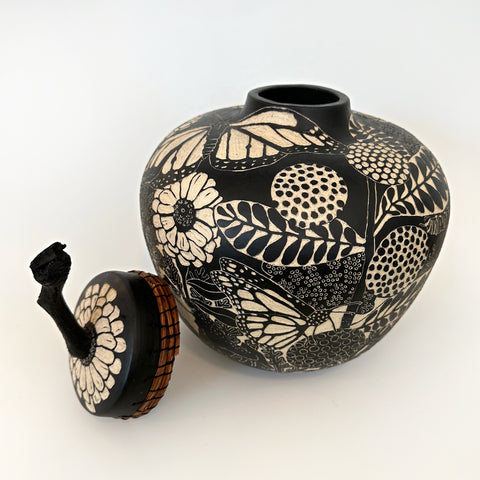 Black and white terra sigillata lidded jar with pine needle edge and grape vine handle feat. grass hoppers, zinnias, butterflies, raven, and other plants by Carolyn Blazeck at Cottage Curator - Sperryville VA Art Gallery