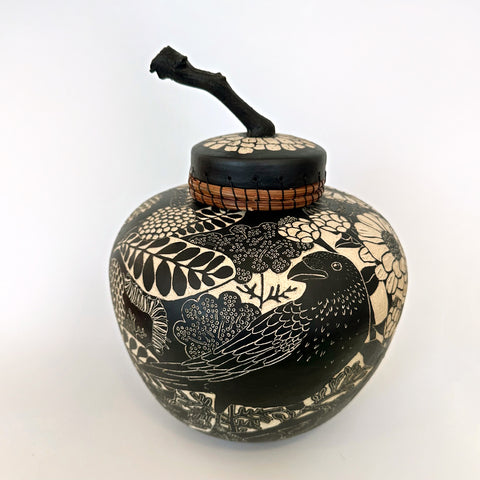 Black and white terra sigillata lidded jar with pine needle edge and grape vine handle feat. grass hoppers, zinnias, butterflies, raven, and other plants by Carolyn Blazeck at Cottage Curator - Sperryville VA Art Gallery