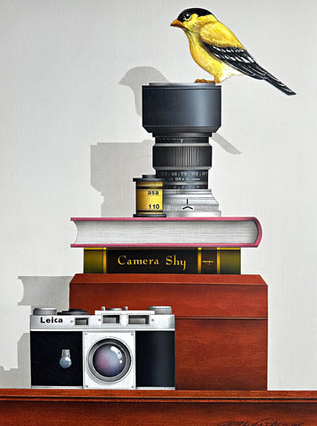 "Camera Shy" 2025 - a painting by James Carter at Nature's Studio - showing a Leica camera, film, books, and a bird on a lens against a white background