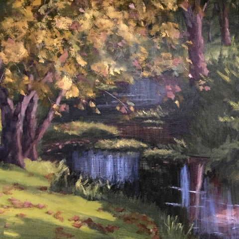 Detail of painting of creek with trees and a blue boat overturned near the edge of the water by Kathy Chumley at Cottage Curator - Sperryville, VA art gallery