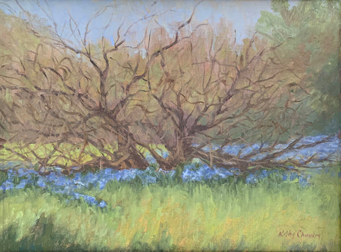 Oil painting of landscape with budding tree and blue wildflowers in the foreground with forest behind by Kathy Chumley at Cottage Curator - Sperryville VA Art Gallery