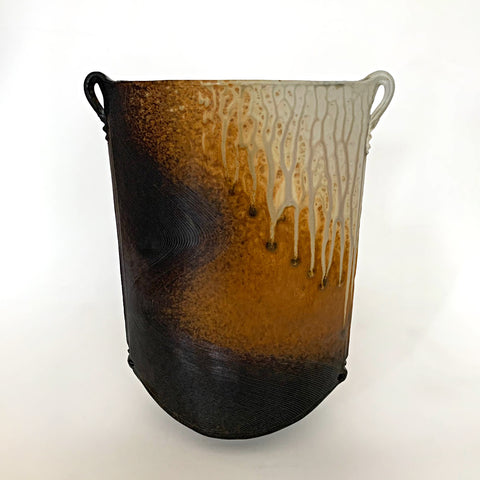 Oval shaped ceramic vessel with two small handles at the top on either side and ochre, white and charcoal colored wood ash glaze by Richard Aerni at Cottage Curator - Sperryville VA Art Gallery