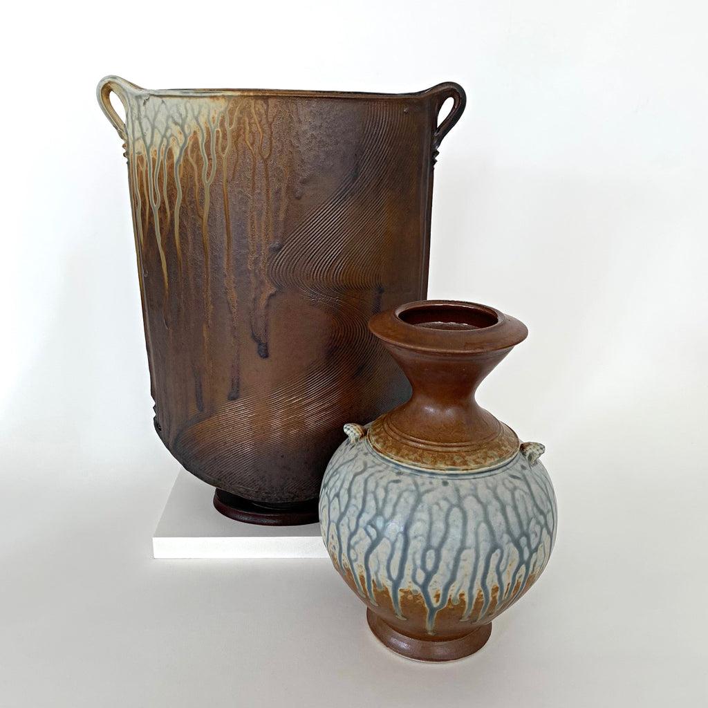 Stoneware wood ash glazed oval vessel with smaller round vase, each with two handles - brown and cream colored glaze by Richard Aerni at Cottage Curator - Sperryville VA Art Gallery