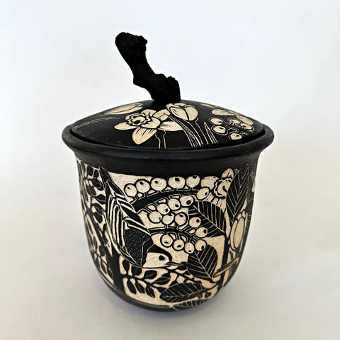 Black and white ceramic lidded vessel with a grapevine handle and sgraffito scenes of crocuses, birds, and other plants by Carolyn Blazeck at Cottage Curator - Sperryville VA Art Gallery