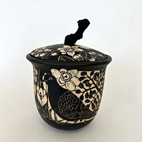 Black and white ceramic lidded vessel with a grapevine handle and sgraffito scenes of crocuses, birds, and other plants by Carolyn Blazeck at Cottage Curator - Sperryville VA Art Gallery