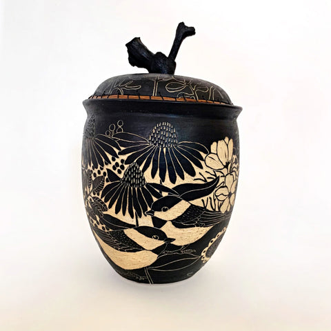 Lidded black and white ceramic vessel with pine needle rim and grapevine lid handle showing a portrait of a chickadees surrounded by plants, carved in sgraffito by Carolyn Blazeck, at Cottage Curator - Sperryville VA Art Gallery
