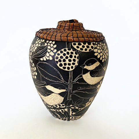 Black and white ceramic vessel with pine needle rim and lid showing a portrait of a chickadees surrounded by plants, carved in sgraffito by Carolyn Blazeck, at Cottage Curator - Sperryville VA Art Gallery