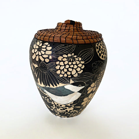 Black and white ceramic vessel with pine needle rim and lid showing a portrait of a chickadee surrounded by plants, carved in sgraffito by Carolyn Blazeck, at Cottage Curator - Sperryville VA Art Gallery