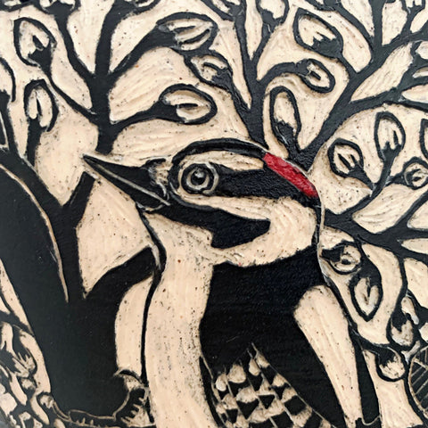 Detail of woodpecker on black and white vessel with pine needle edge in black terra sigillata and sgraffito with woodpeckers by Carolyn Blazeck at Cottage Curator - Sperryville VA Art Gallery