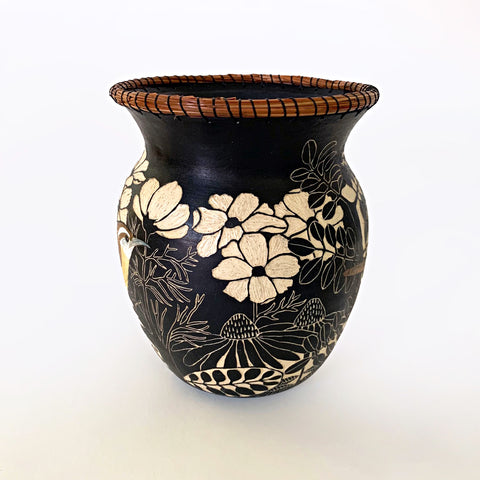Black and white ceramic vessel with portrait of a carolina wren surrounded by plants in sgraffito with pine needles sewn around the rim by Carolyn Blazeck at Cottage Curator - Sperryville VA Art Gallery