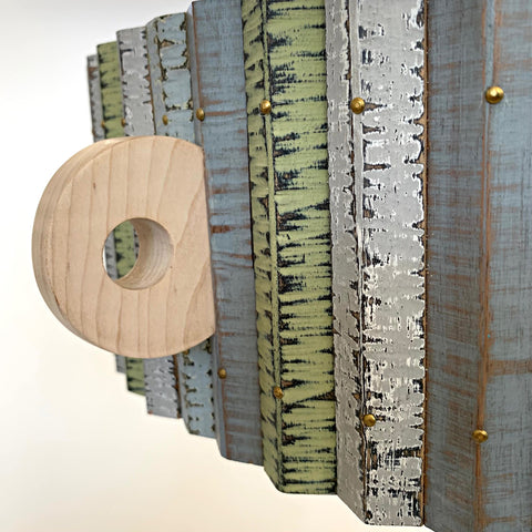 Detail of circular handle and stripes on round, three-legged table with drawer, circular handle in maple, oak, and cherry with milkpainted, multi-colored vertical stripes around outside edge by Christina Boy at Cottage Curator - Sperryville VA Art Gallery