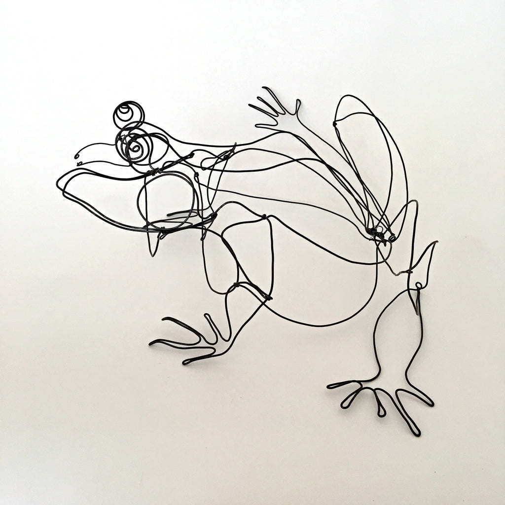 Black wire sculpture of frog by Janet Brome