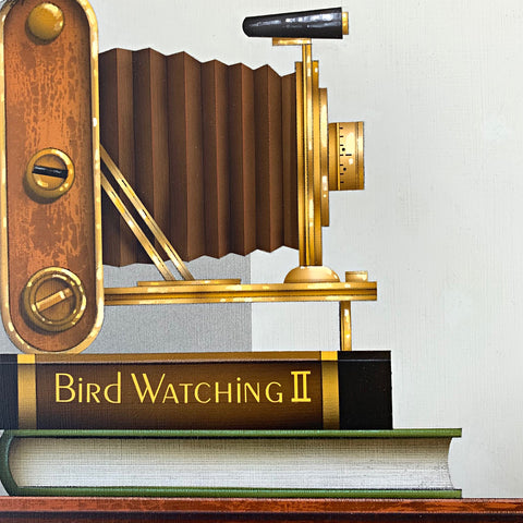 Detail of realistic acrylic painting of old-fashioned accordion camera atop two books, one labelled Bird Watching II by James Carter at Cottage Curator - Sperryville VA Art Gallery