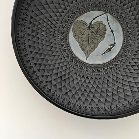 Detail of gray, black and blue ceramic vessel with triangular pattern and leaf and morning glory imprint by Suzanne Crane at Cottage Curator - Sperryville VA Art Gallery