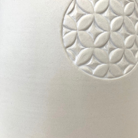 Detail of white porcelain vessel with handle and circle with pattern on the side by Yoshi Fujii at Cottage Curator - Sperryville VA Art Gallery
