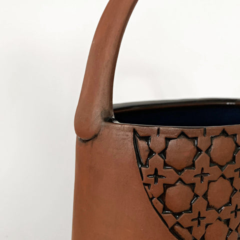 Detail of stoneware vessel in natural tan clay color with handle and carved patterned circles by Yoshi Fujii at Cottage Curator - Sperryville VA Art Gallery