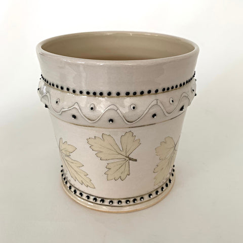 Stoneware vessel with leaves and black trim detailing and cream glaze by D.D. Lecky at Cottage Curator - Sperryville VA Art Gallery