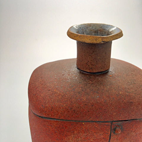Detail of red ceramic industrial flask vessel with seams by artist Steve Palmer