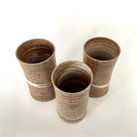 Set of three cylindrical vases in brown textured finish with white swirls by Virginia Rood Pates at Cottage Curator - Sperryville VA Art Gallery