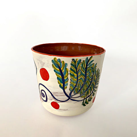 Ceramic pot with yellow, green, blue and purple plants and red polka dots with clay interior by Sara Schneidman at Cottage Curator - Sperryville VA Art Gallery